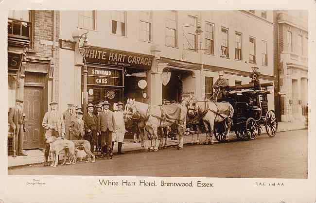 Photograph of the exterior with coach and horses.